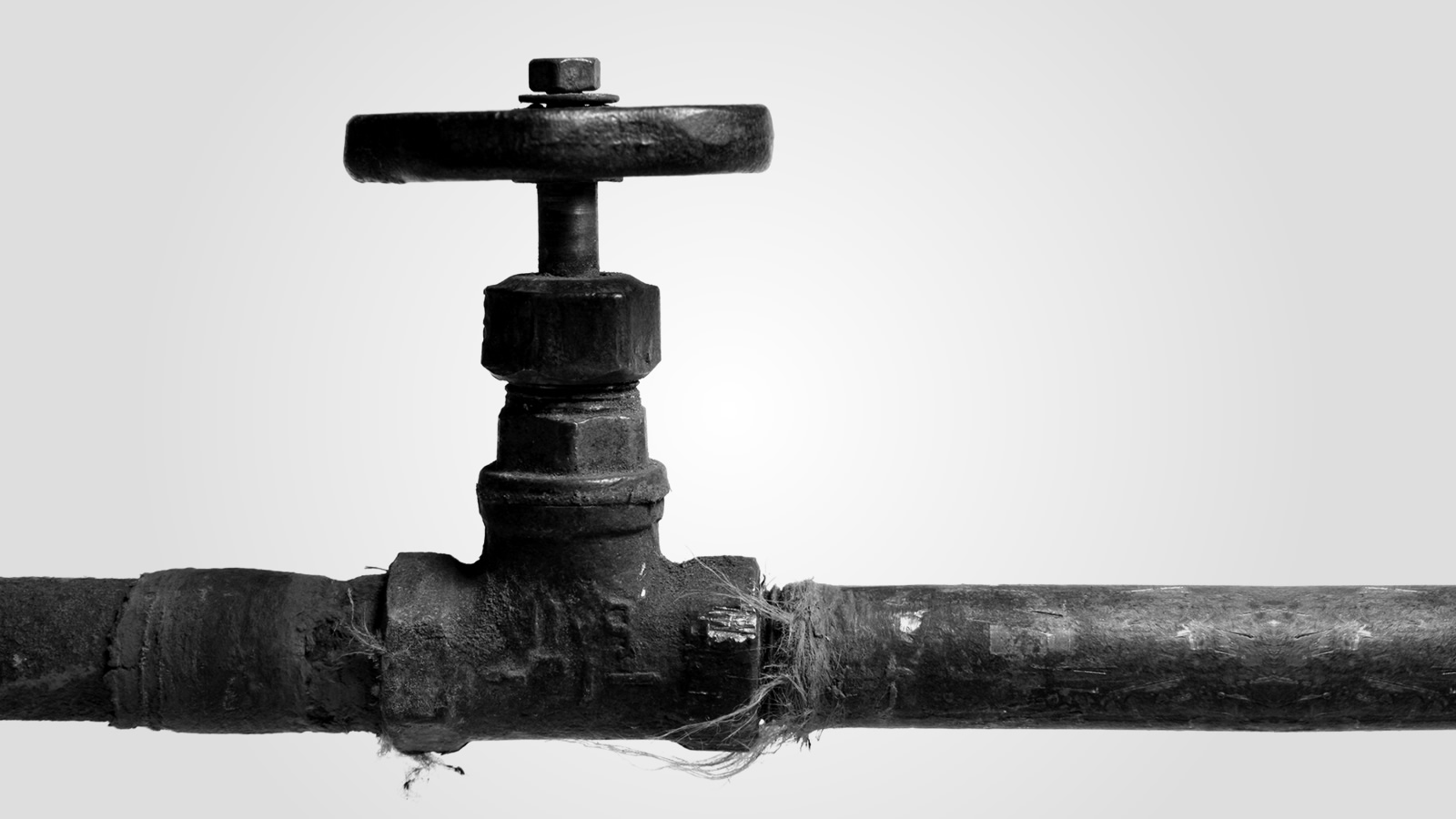 A shut-off valve on an old metal pipe