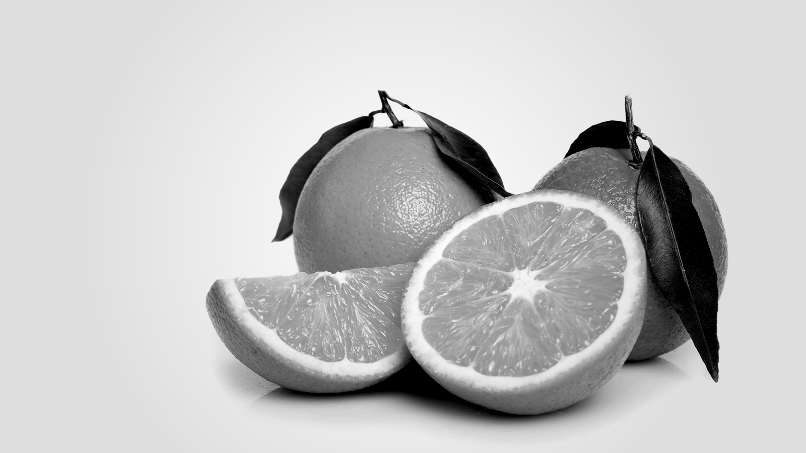A few oranges, one sliced in half