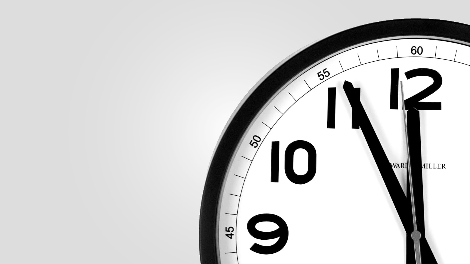 A wall clock reading a few minutes to midnight